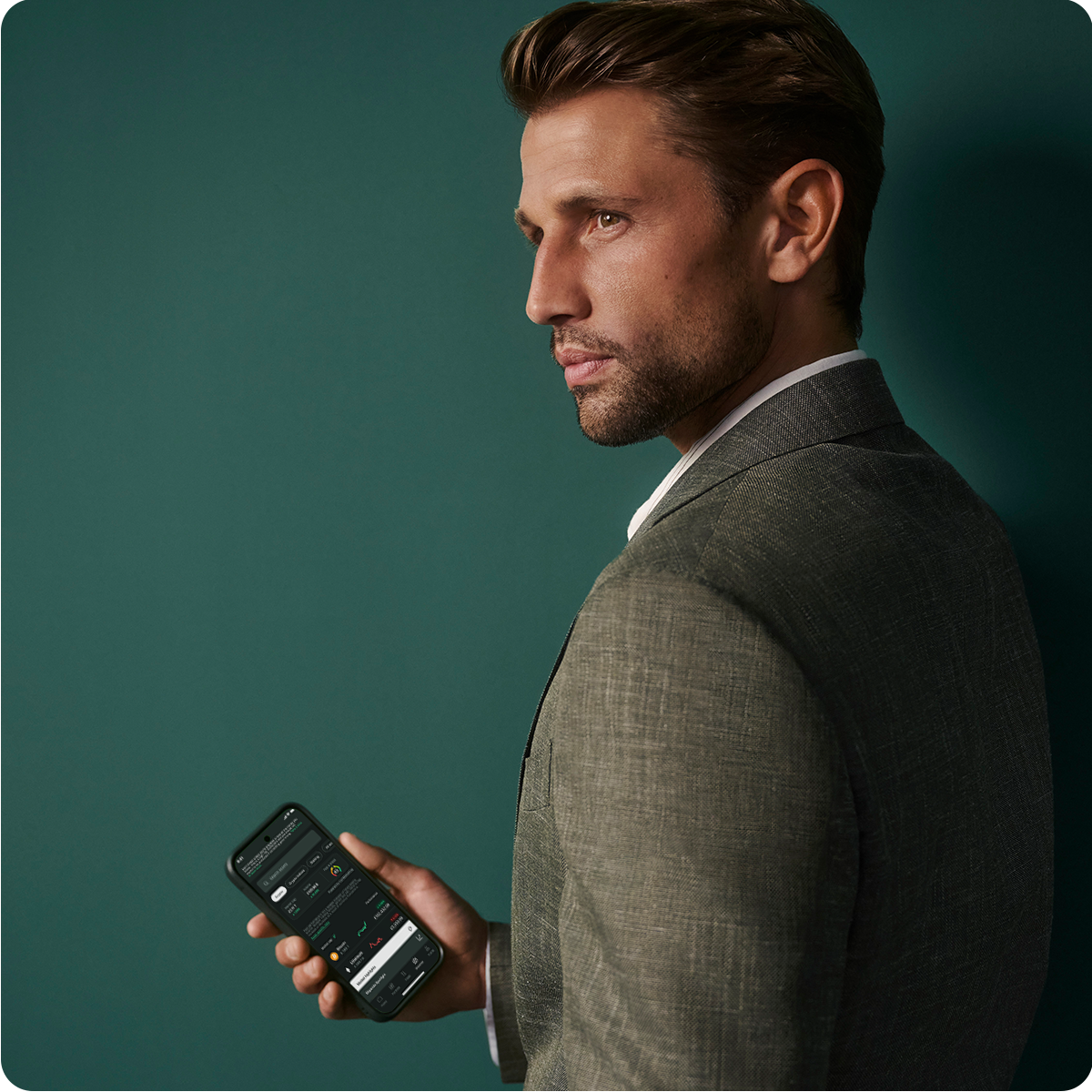 man holding a phone on green background