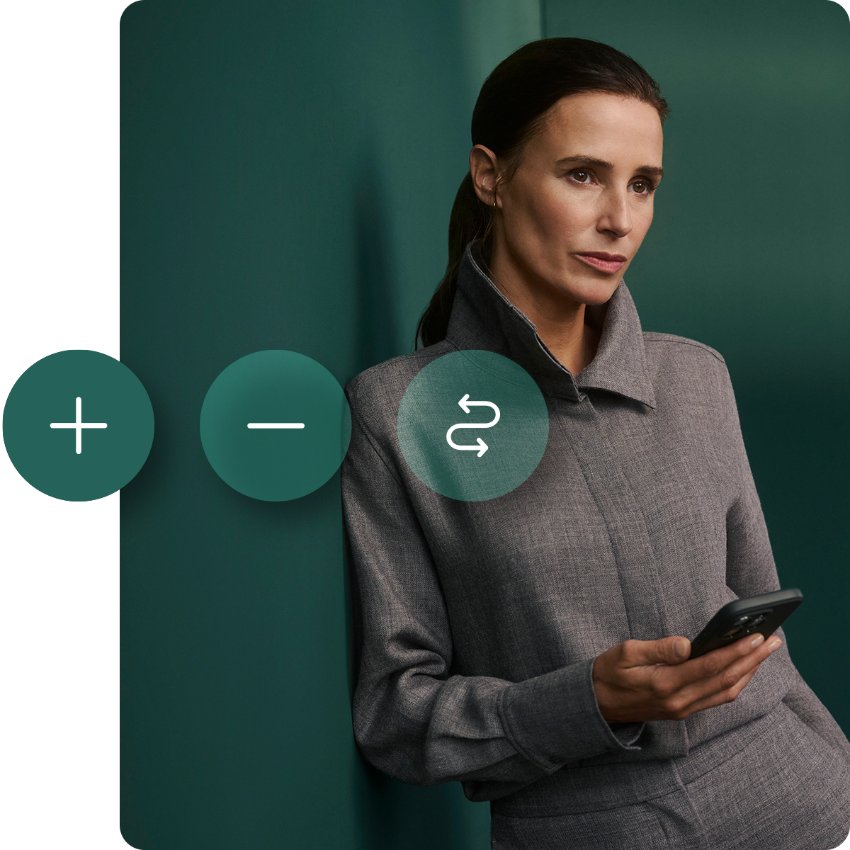 Woman in a gray outfit holding a phone, standing against a green wall with overlay icons of plus, minus, and refresh symbols.